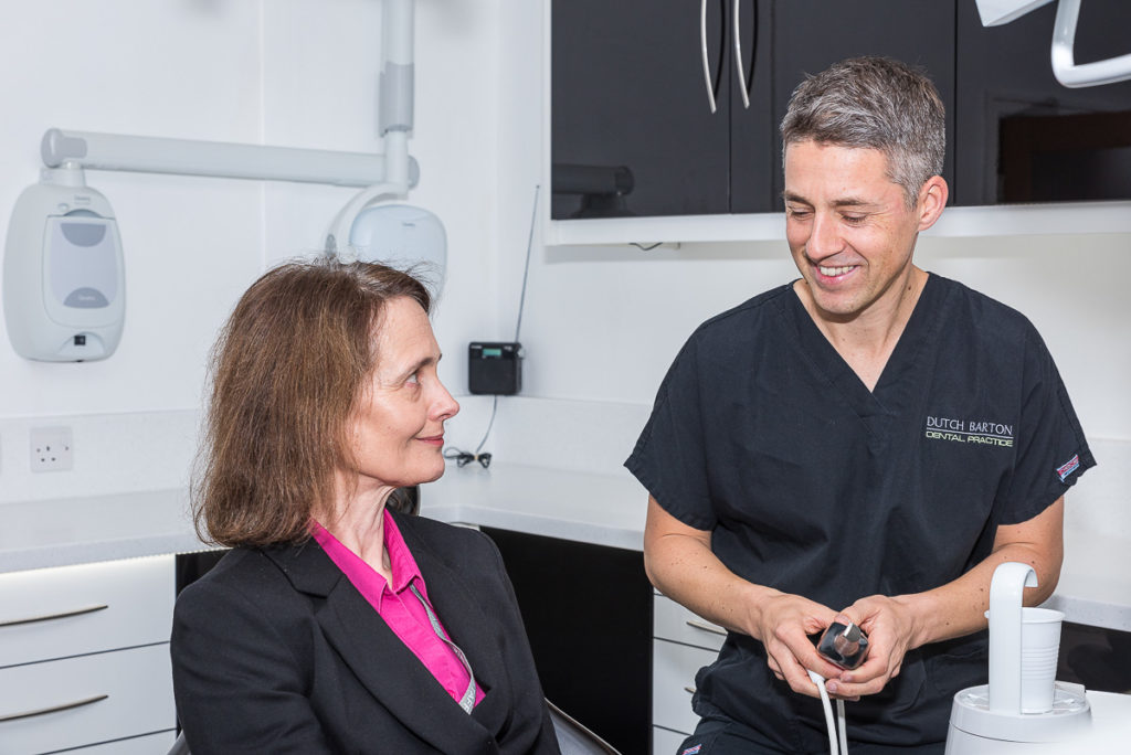 Dentist James MacDonald consulting a female patient